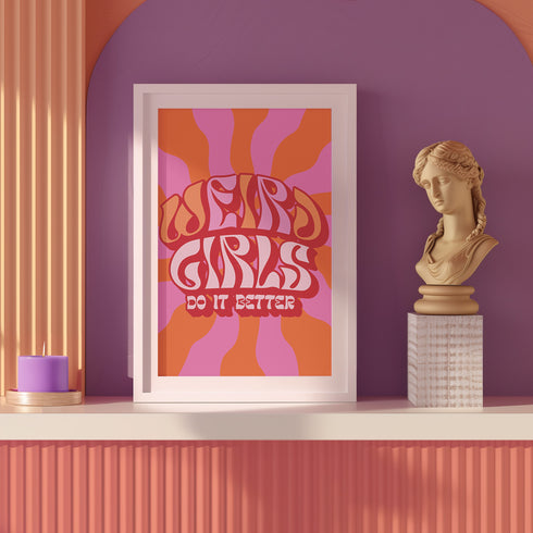 Retro-style poster with psychedelic 1970s-inspired design. Text reads "WEIRD GIRLS DO IT BETTER" in wavy, groovy lettering. Pink and orange sunburst background. Centered text surrounded by curved rays. Bold red frame with scalloped edges. Vibrant colors and playful typography create a vintage hippie vibe. Square format print with rounded corners. Perfect for fans of retro aesthetics and empowering slogans.